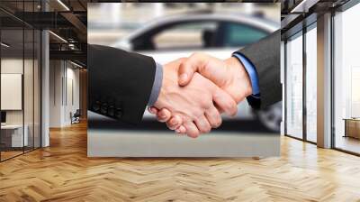 two men shaking hands after a successful car purchase Wall mural