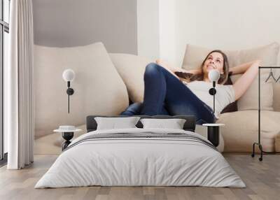 Woman relaxing on her couch Wall mural