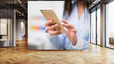 Woman using her mobile phone Wall mural