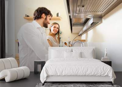 Young couple doing dishes Wall mural