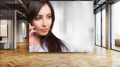 young woman using a mobile phone Wall mural