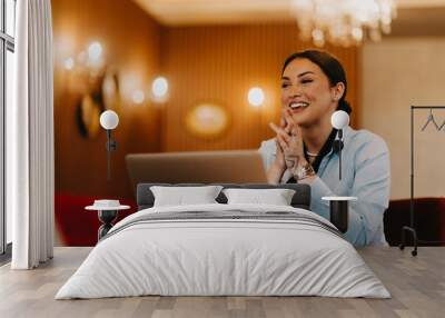 Radiant Latina businesswoman confidently leads business meeting over coffee. Wall mural