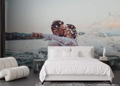 Romantic couple kissing in the sea at sunset. High quality photo Wall mural