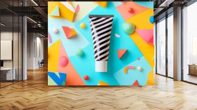 A vibrant cosmetic tube mockup surrounded by colorful geometric shapes creates playful and artistic display. striped design of tube stands out against bright background Wall mural