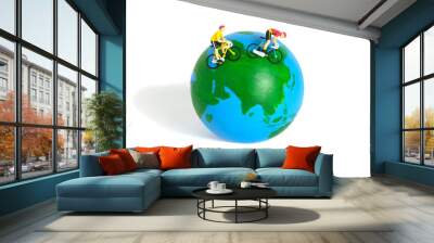 Miniature people toy figure photography. World bicycle day or tour around the world concept. A biker cycling above earth globe, isolated on white background. Wall mural