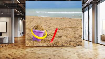 children's toys on the beach. bucket and shovel in the sand Wall mural