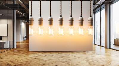 Row of glowing vintage light bulbs against a white wall. Concepts. ideas, innovation, creativity, solutions. Wall mural