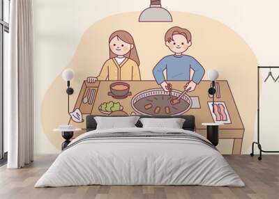 Korean samgyeopsal restaurant. A family of four is sitting at the table happily. Unique culture of grilled pork cut with scissors and spoon drawer on the table.flat vector illus Wall mural