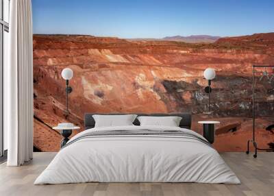 Deep pit of red iron ore mine in Pilbara region in Western Australia Wall mural