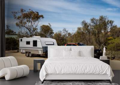 Off road pickup car with air intakes and a white caravan trailer in Western Australia Wall mural