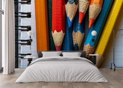 A close-up of colorful pencils arranged on a notebook, showcasing a vibrant collection of art supplies. Wall mural