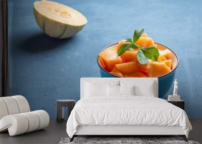 Fresh melon cut into pieces in a bowl - image Wall mural