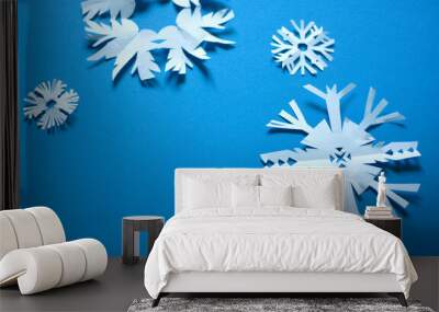 White paper craft snowflakes on a blue background Wall mural