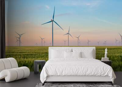 Group of windmills for electric power production in the green field of wheat Wall mural