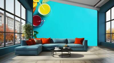 A light blue background with two cocktail glasses and fruits on the left. Top view summer banner with plenty of copy space. Wall mural