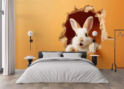 An adorable white rabbit peeks through a torn orange paper wall, creating a playful and unexpected image Wall mural