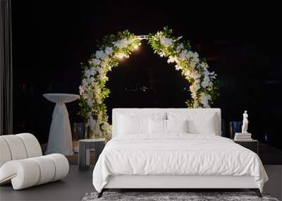 Night wedding ceremony with round arch, flowers, bulb lights and candles on the backyard outdoors, copy space. Wedding decor Wall mural