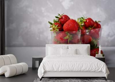 Red ripe strawberry in glass bowls on gray concrete table background, copy space. Healthy food concept Wall mural