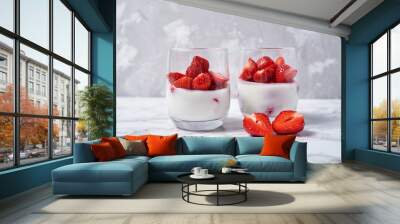 Two glasses of healthy yogurt with fresh sliced strawberry on white marble table background, copy space. Healthy breakfast, food concept Wall mural