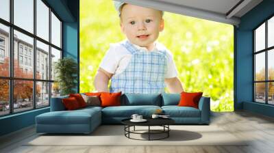 Cute little baby in summer  park on the grass. Sweet baby outdoo Wall mural