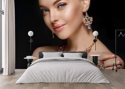 Model in set of jewellery. Luxury girl in shine jewelry from precious stones, diamonds. Beautiful woman in a necklace, earrings and big ring. Beauty and accessories. Wall mural