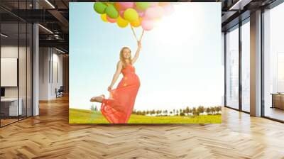 Young healthy beauty pregnant woman with balloons  outdoors. A g Wall mural