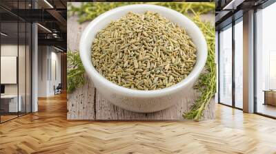 Fennel seeds in a glass bowl on natural background. Wall mural