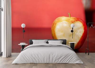 Close-up shot of an apple with a carved heart on a wooden table Wall mural