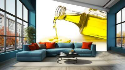 pouring olive oil from glass bottle against white background Wall mural