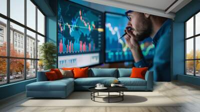 Man analyzes investment portfolio on computer screens in evening Wall mural