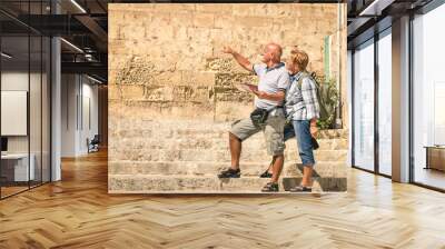 Happy senior couple exploring old town of la Valletta Wall mural