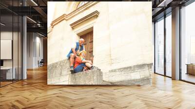 Happy senior couple taking selfie together in San Marino old town castle - Active elderly and travel lifestyle concept with retired mature people at Italy roadtrip - Soft sunshine halo warm filter Wall mural