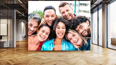 Multi generation guys and girls taking selfie outdoors with backlight - Happy milenial friendship concept on young multiethnic people having fun day together Wall mural