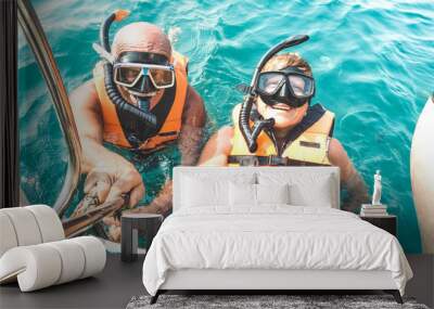 Retired couple taking happy selfie in tropical sea excursion with life vests and snorkel masks - Boat trip snorkeling in exotic scenarios on active elderly and senior travel concept around world Wall mural