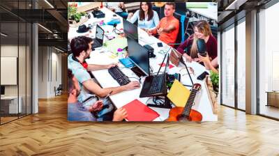 Young people employee workers on computer at urban alternative studio - Human resources and business concept in co working space - Start up entrepreneurs inside modern office - Bright contrast filter Wall mural