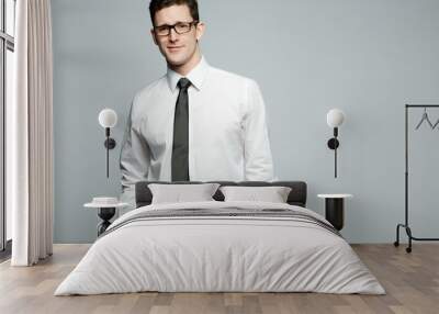 Handsome businessman in white shirt on gray background. Wall mural