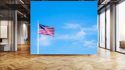 Amaerican flag on pole with blue sky Wall mural