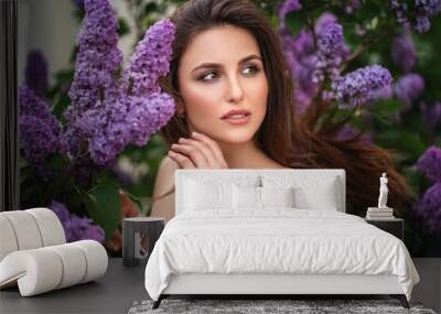 portrait of a woman in lilac. Her hair flutters in the wind Wall mural