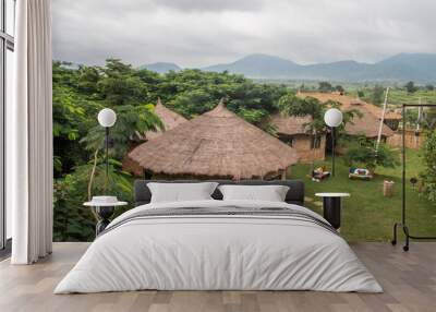 African lodge for tourists, with round shaped traditional houses called Tukul, with colorful benches around, made of natural materials, environmental friendly Wall mural