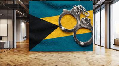 Flag of Bahamas and police handcuffs. Crime and offenses in country Concept
 Wall mural