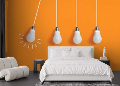 Hanging light bulbs with glowing. one different.  business idea concept on isolated background Wall mural