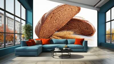 Two halves a loaf of rye bread and wheat ears isolated on white background. Wall mural