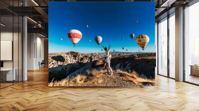 Couple in love among balloons. A guy proposes to a girl. Couple in love in Cappadocia. Couple in Turkey. Honeymoon in the mountains. Man and woman traveling. Flying on balloons. Wedding. Journey. Love Wall mural