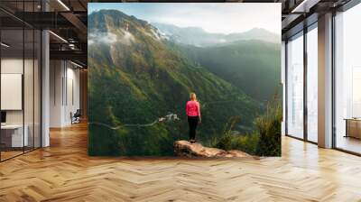 Girl meets sunrise in the mountains. Girl traveling to Sri Lanka. Mountain sports. Athlete happy finish. Mountain tourism. Walking tour. The journey to the mountains. Man on the edge of the mountain Wall mural