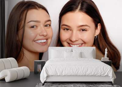 make up and skin care concept - Portrait of a two beautiful sexy young women - Isolated on white. Two smiling attractive girl friends Wall mural