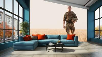 Soldier man standing against a field. Portrait of happy military soldier in boot camp. US Army soldier in the Mission. war and emotional concept. Wall mural