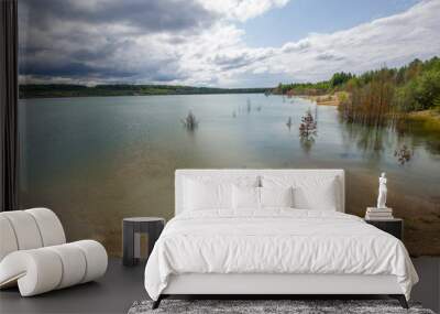 Flooded clay quarry lake with green water landscape Wall mural