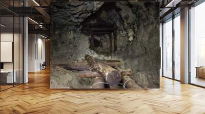 Underground abandoned gold ore mine shaft tunnel gallery with wooden timbering Wall mural