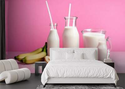 Tasty rice milk porridge with banana in white mask and milk in milkman on pink background with copyspace Wall mural