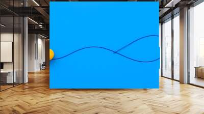 Dynamic Minimalist Composition with Yellow Spheres and Flowing Blue Line on Blue Surface Wall mural